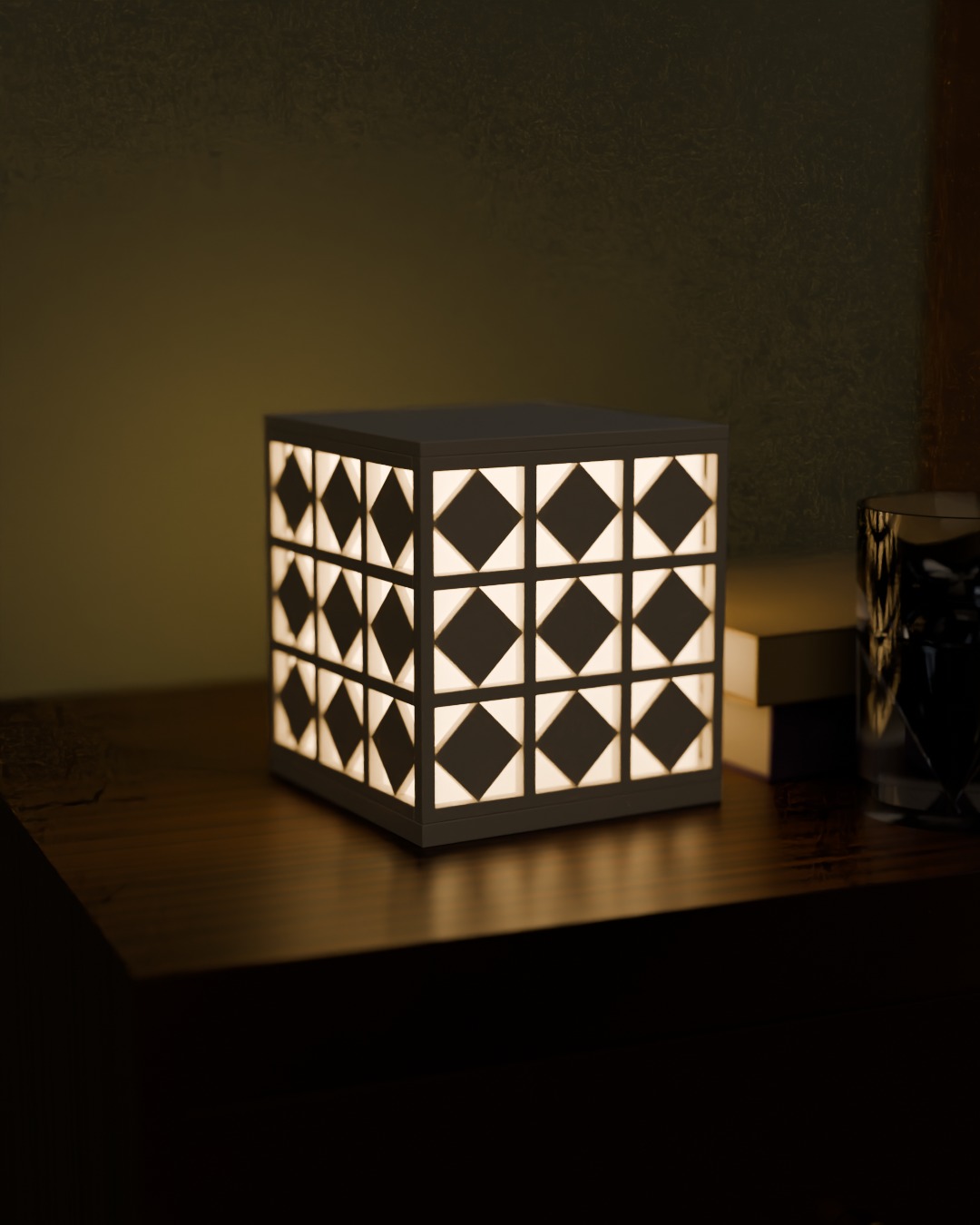 ANGIN cordless lamp in bone white, switched on, on a bedside table
