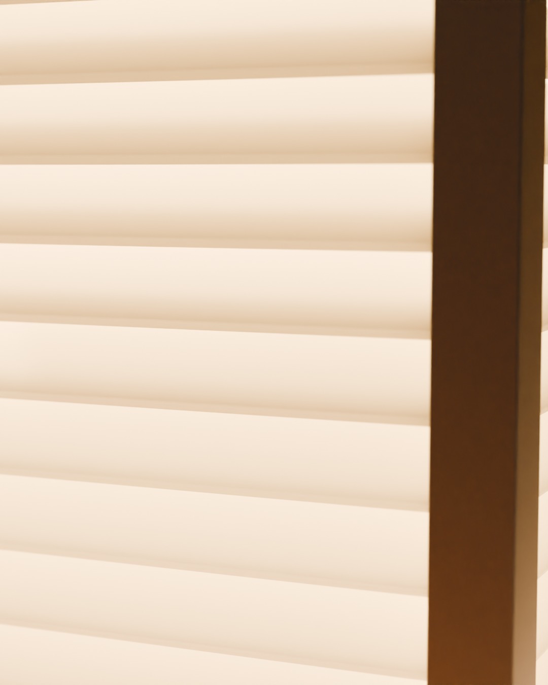 Close-up of the BIDAI table lamp in bone white, switched on, on a sideboard, 50-degree louvres against the corner post
