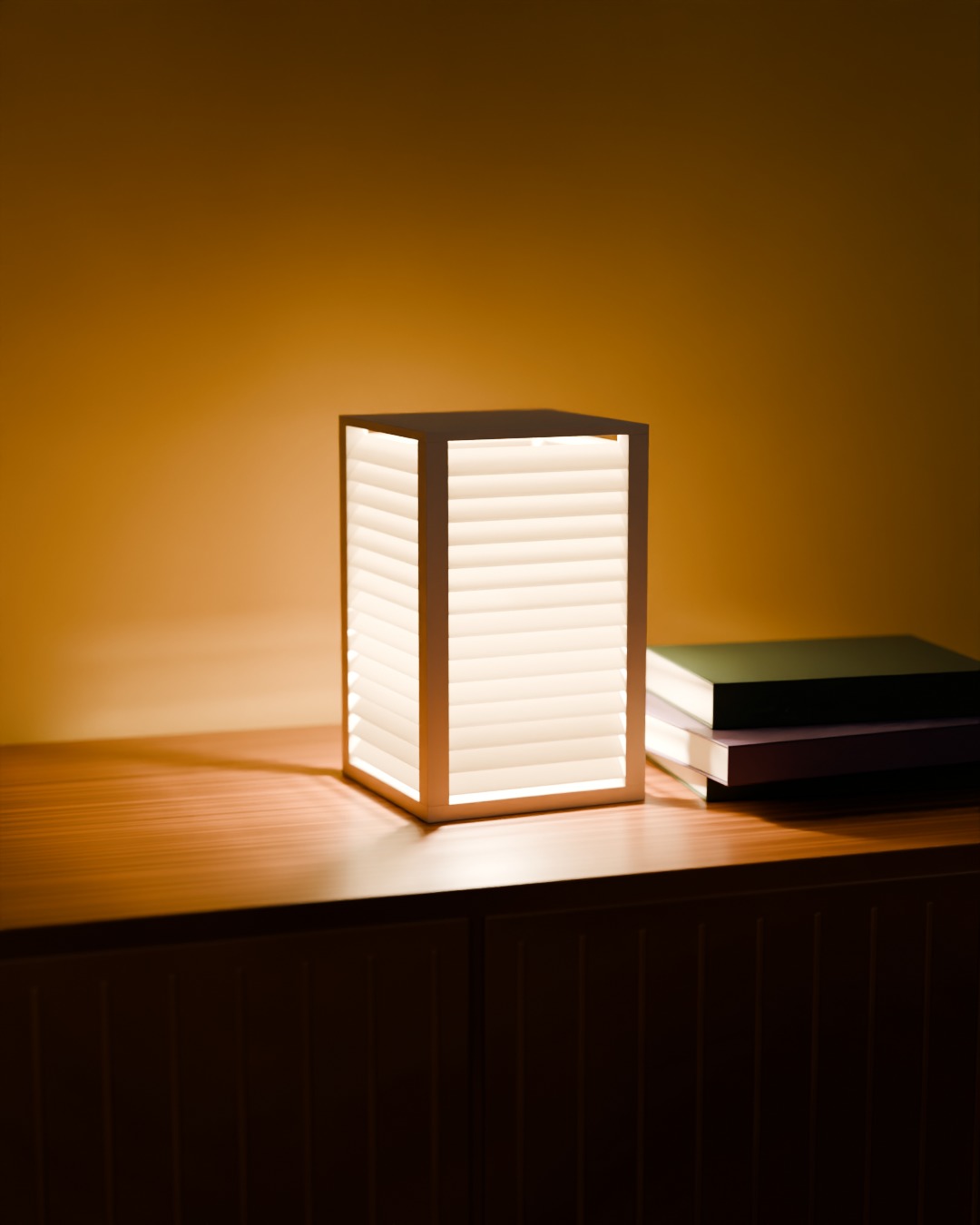 BIDAI table lamp in bone white, switched on, on a sideboard
