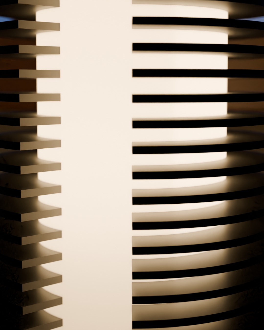 Close-up of the COLUMN table lamp in graphite, switched on, on a work desk, heat-sink rings and the lit window