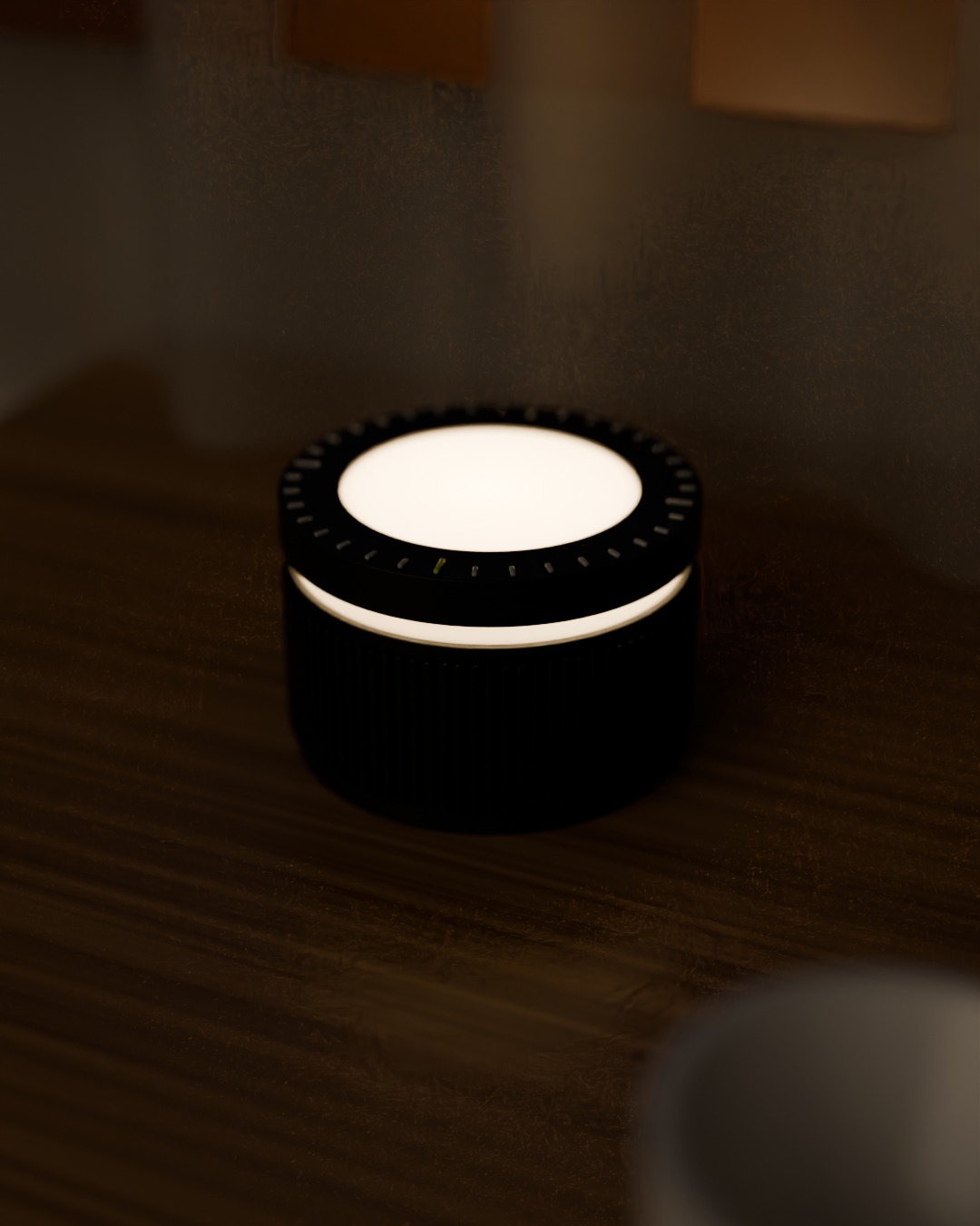 DIAL cordless lamp in graphite, switched on, on a work desk
