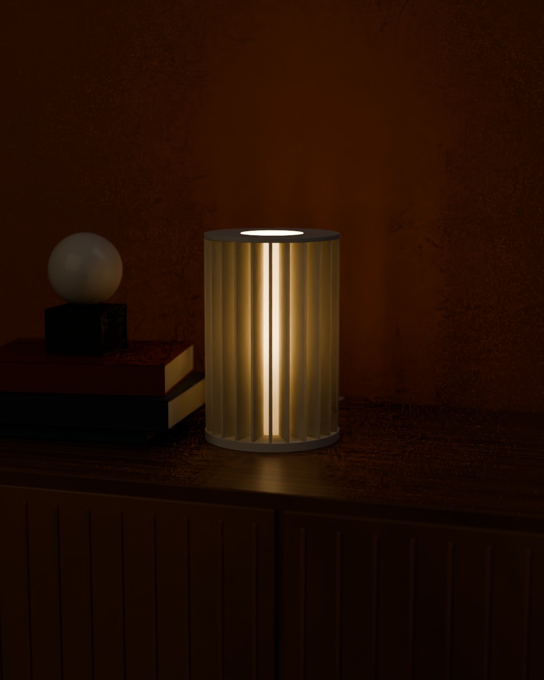 SIRIP table lamp in bone white, switched on, on a sideboard