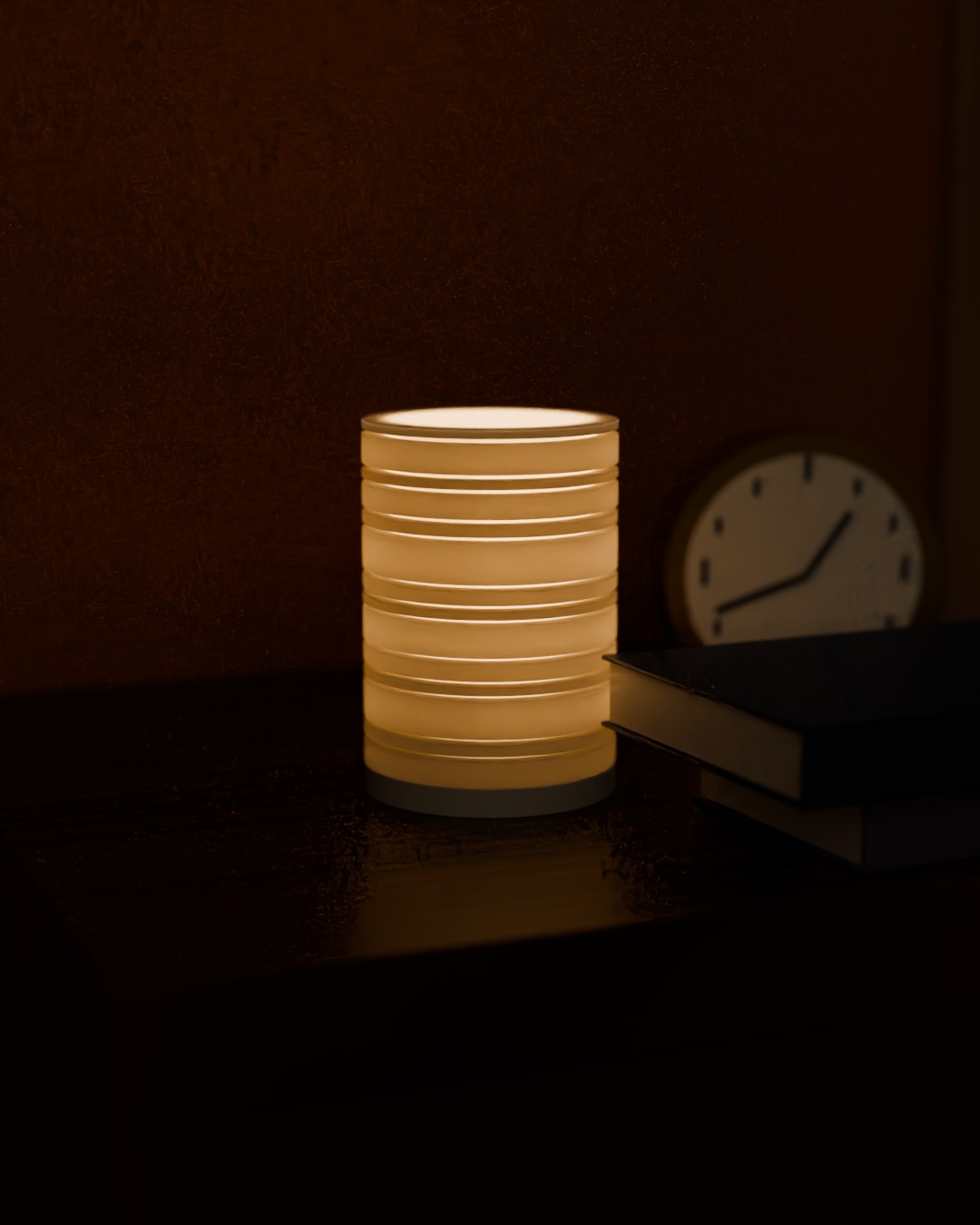 TERAS cordless lamp in bone white, switched on, on a bedside table